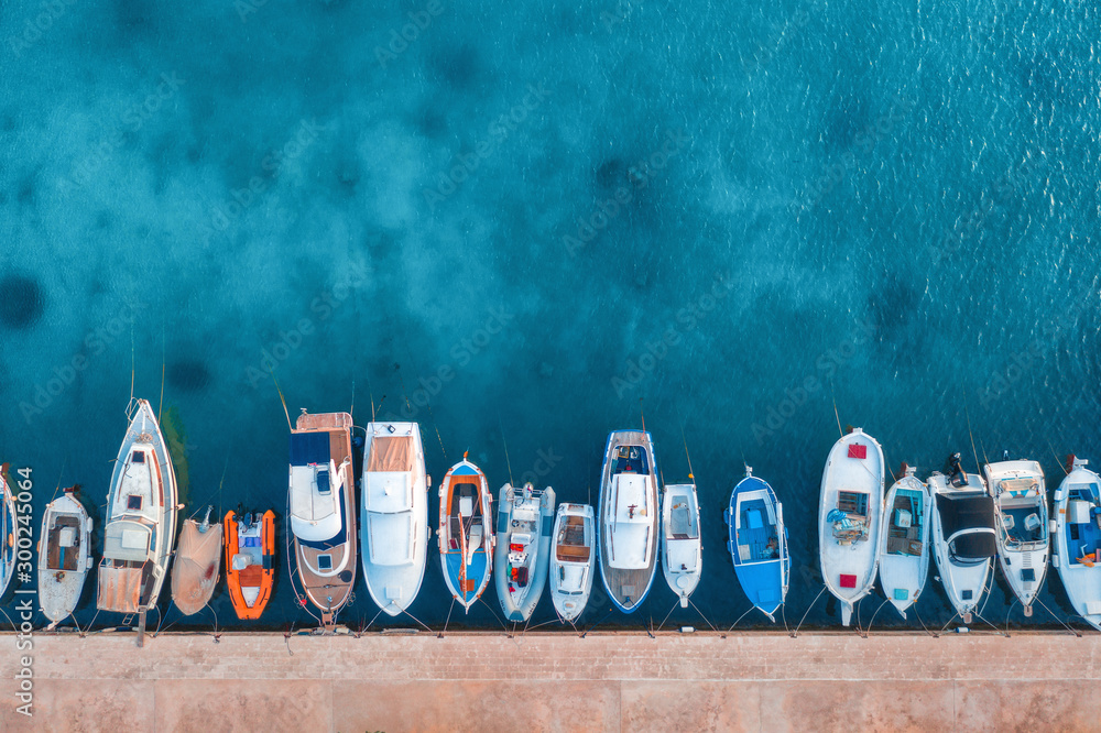 Aerial view of the boats and yachts on tropical sea coast at sunset in summer. Colorful landscape wi