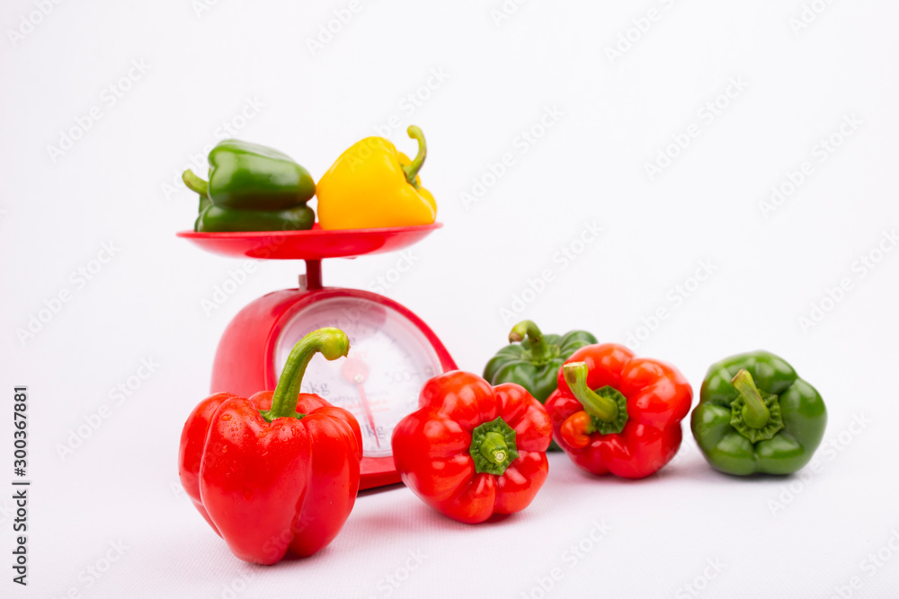 Fresh bell peppers and scales on white background, red, yellow, green bell peppers, organic vegetabl