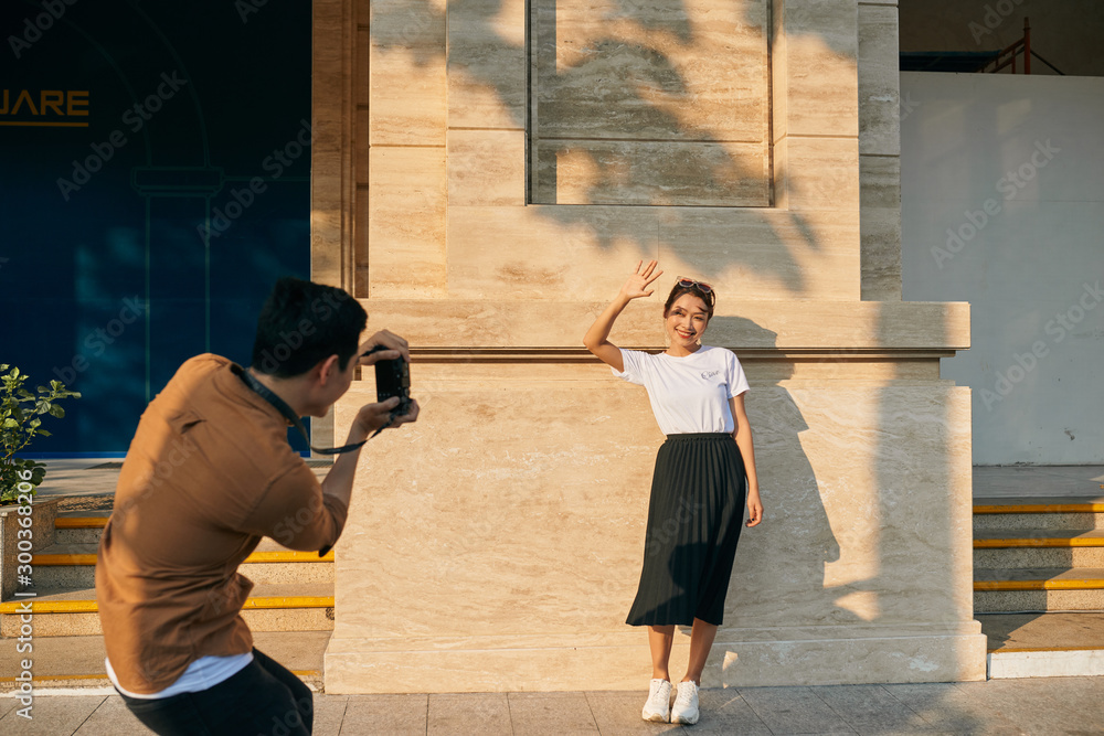 summer holidays and dating concept - couple taking photo picture in the city