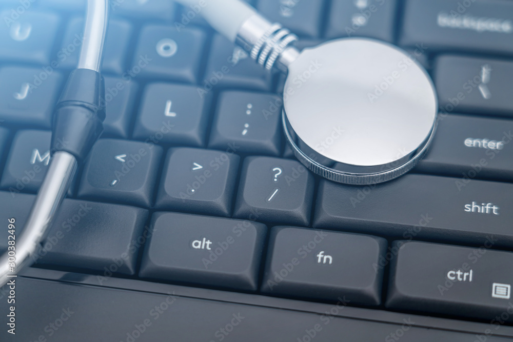 Stethoscope on black computer keyboard - network information leak concept picture