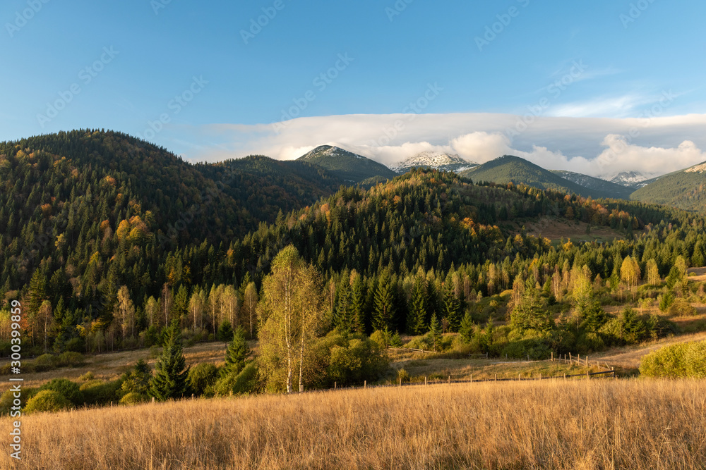 Amazing mountain landscape with colorful vivid sunset on the blue sky