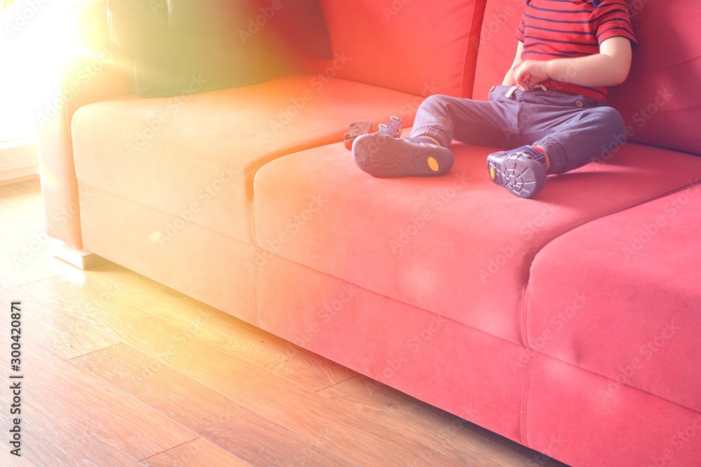 child sitting on the sofa at home