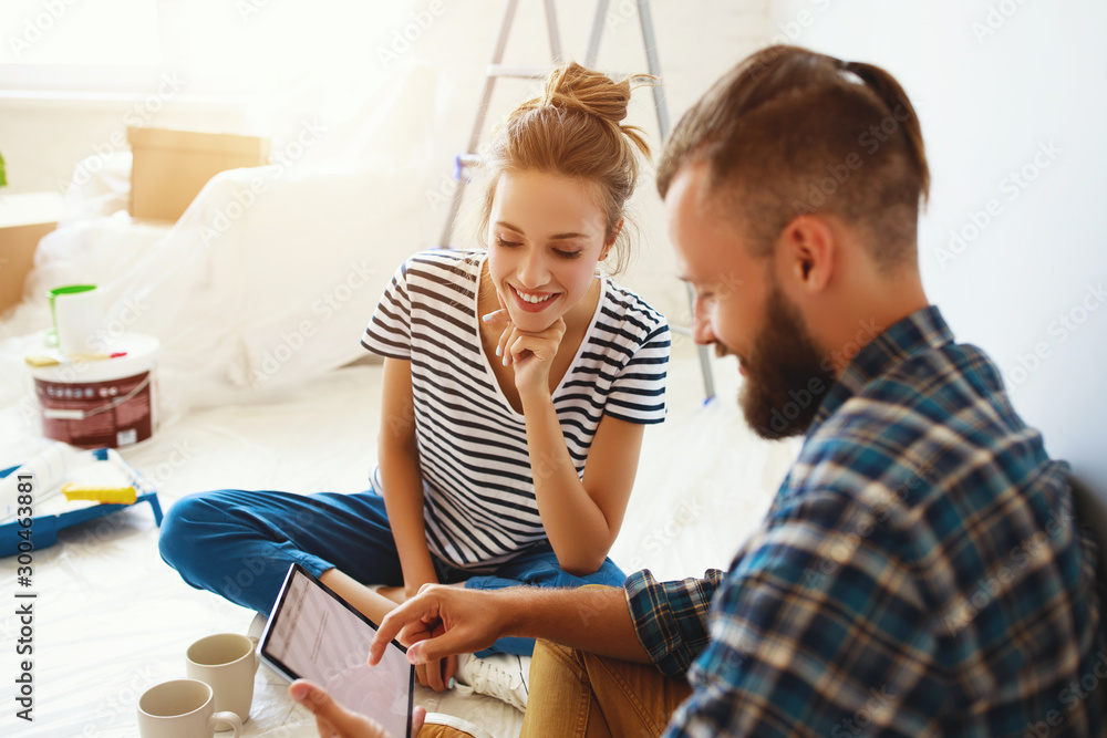 young happy family married couple dreams of renovating  house and planning  design project.