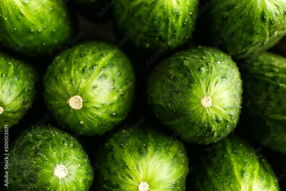 Fresh green cucumbers as background