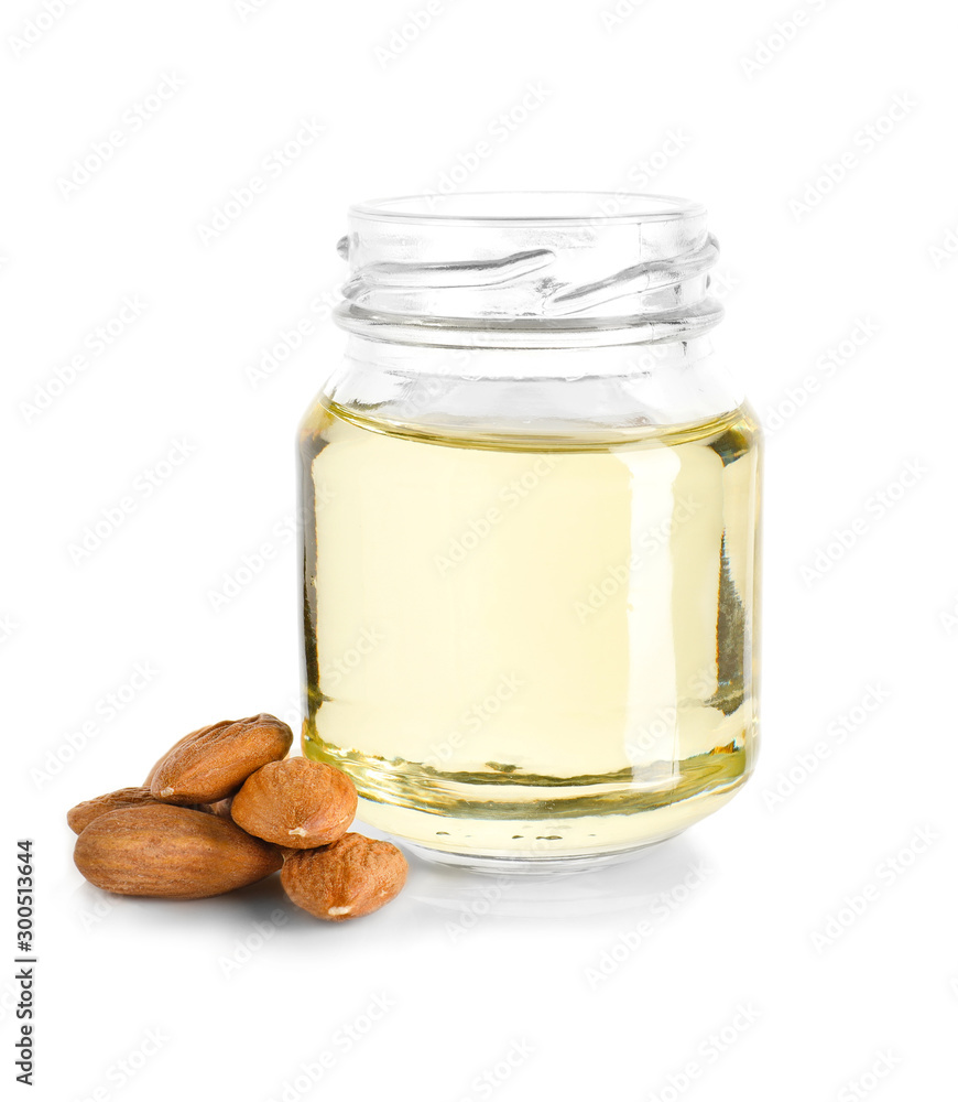 Jar of almond oil on white background