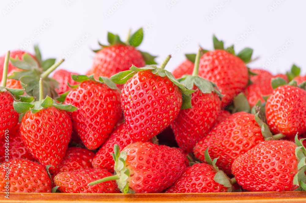 Beautiful and delicious strawberries in a wooden box basket, concept of organic farming, fresh direc