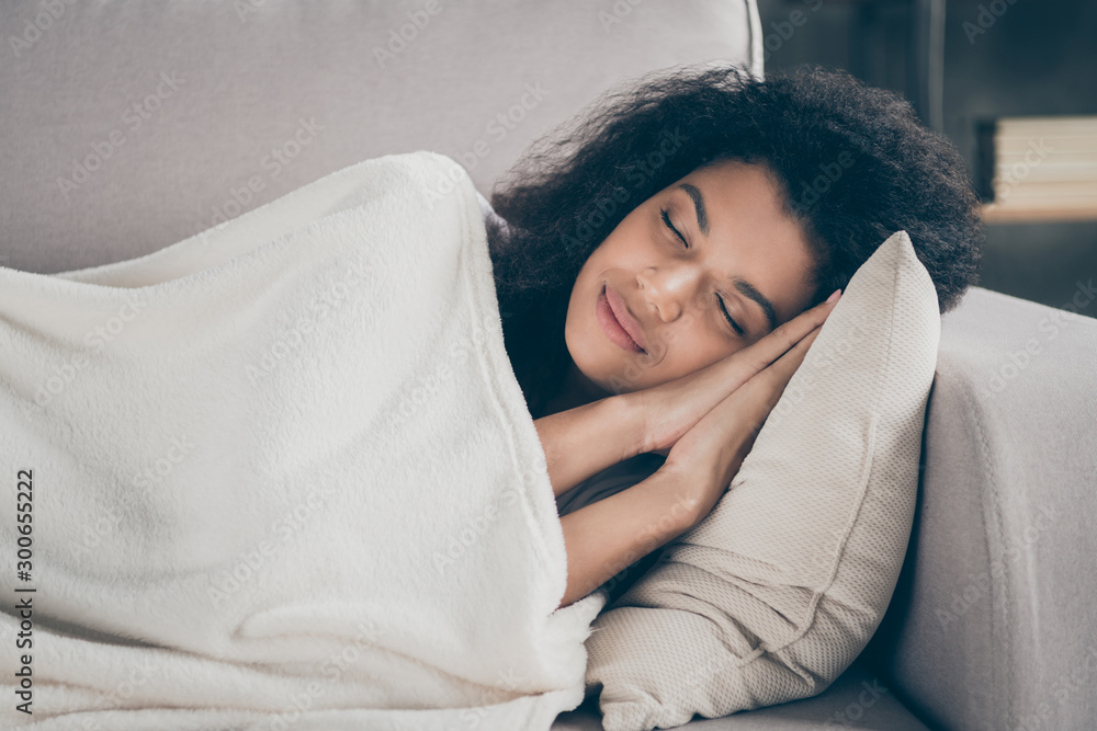 Profile photo of beautiful dark skin wavy lady holding hands under head eyes closed having daydream 