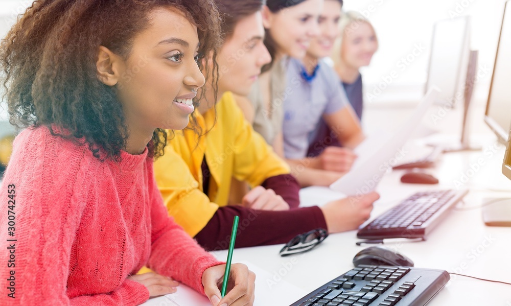 Young students studying with computers