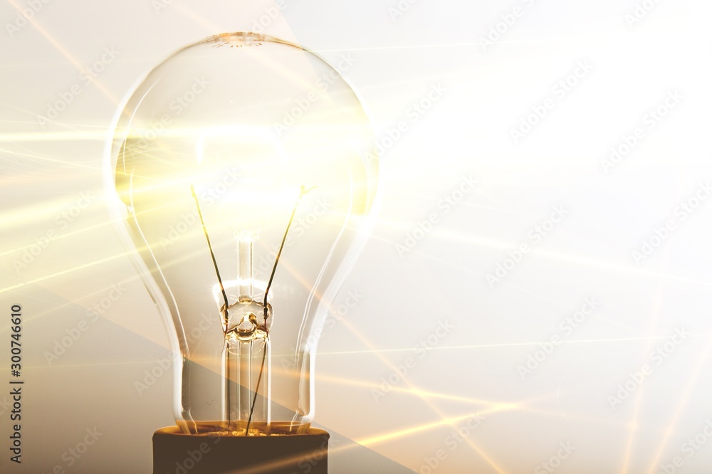 Glowing glass light bulb on background