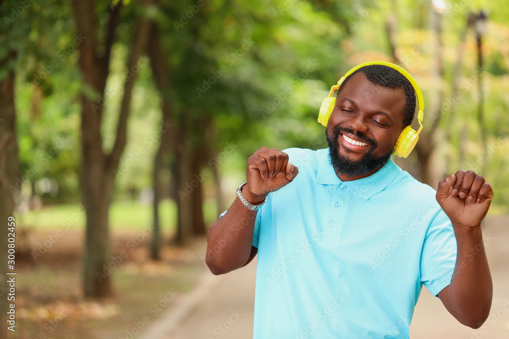 Handsome African-American man listening to music outdoors