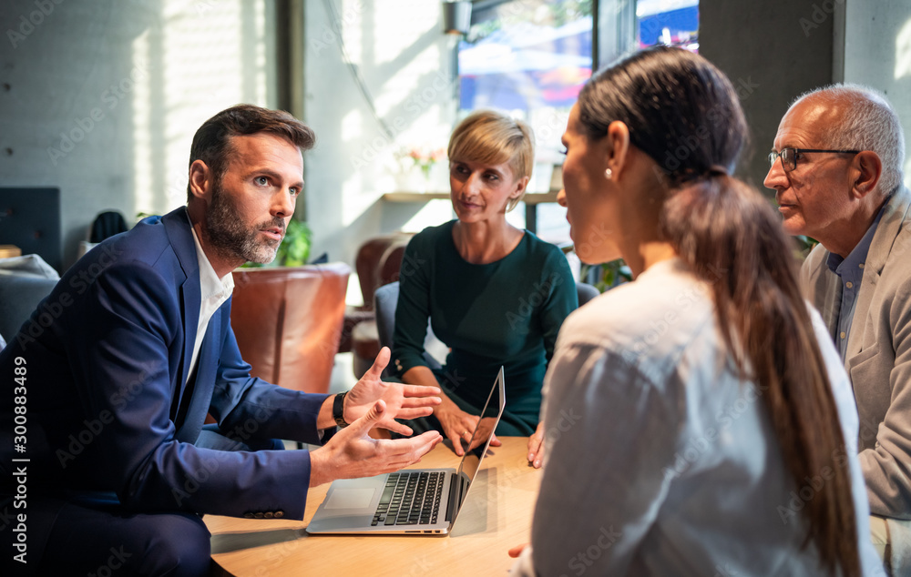 Business people talking about project in a cafe