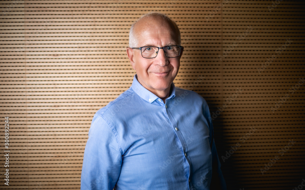 Portrait of senior businessman with eyeglasses looking at camera