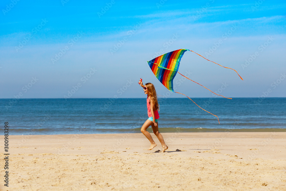 Profile portrait of girl run with kite on a beach