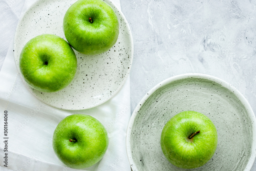 ripe green apples stone table background top view