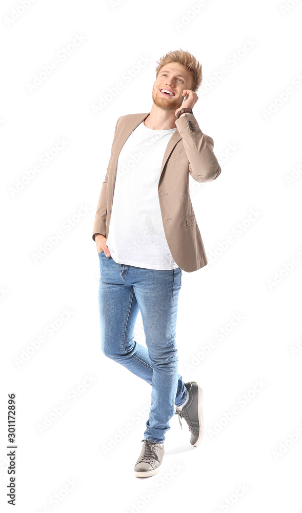 Portrait of young man talking by mobile phone on white background