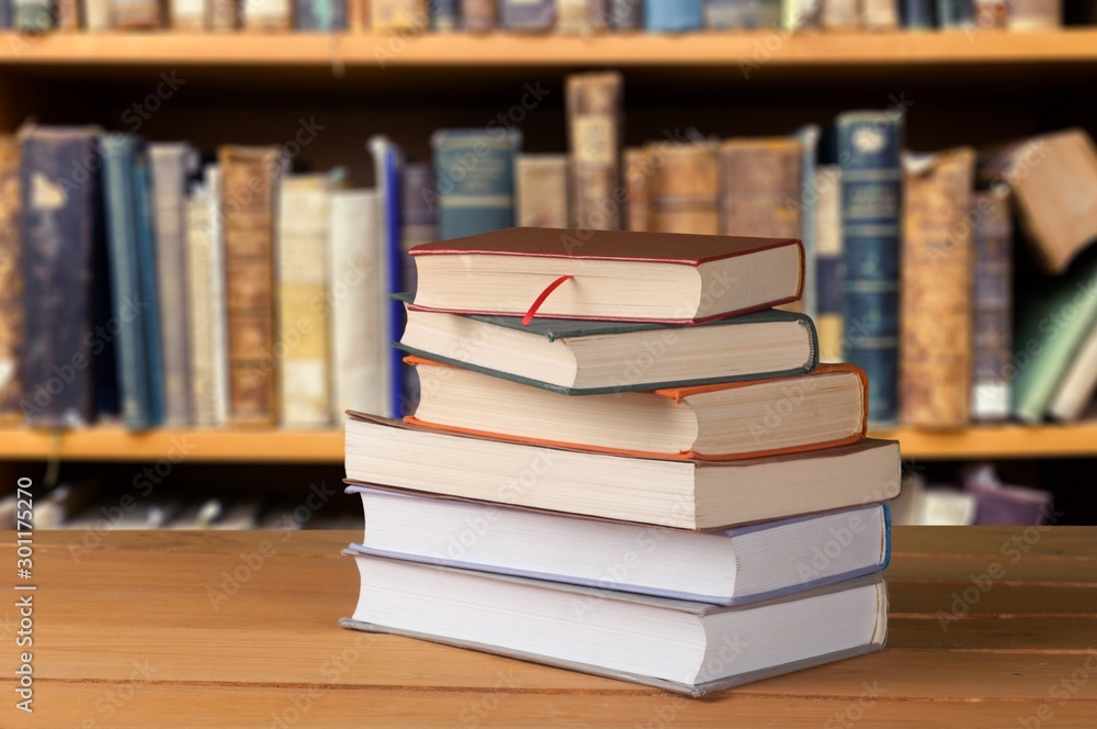 Close-up Black reading glasses and book on blurred library background