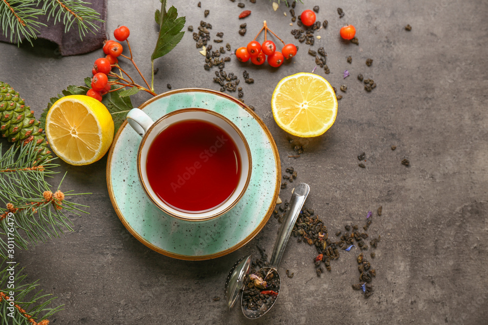 Composition with cup of hot tea on grey background