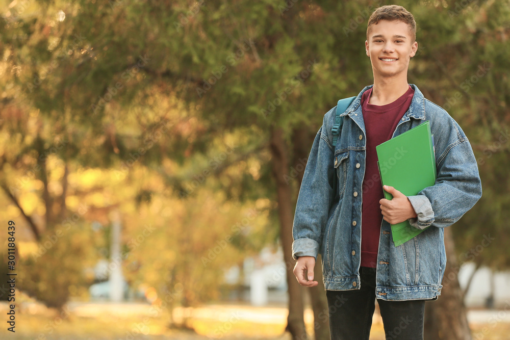 Portrait of teenage male student outdoors