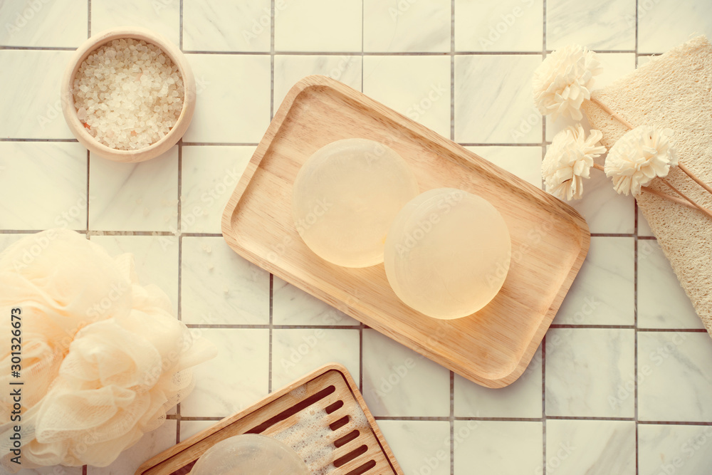 Natural soap and salt on a wooden board, hygiene items for bath and spa.