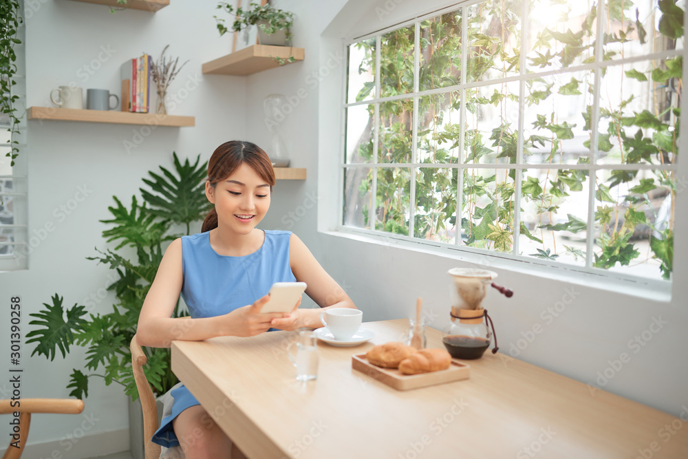 亚洲女性早餐时打电话