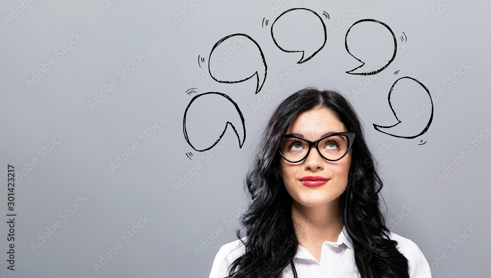 Speech bubbles with young businesswoman in a thoughtful face