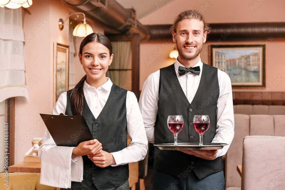 Portrait of young waiters in restaurant