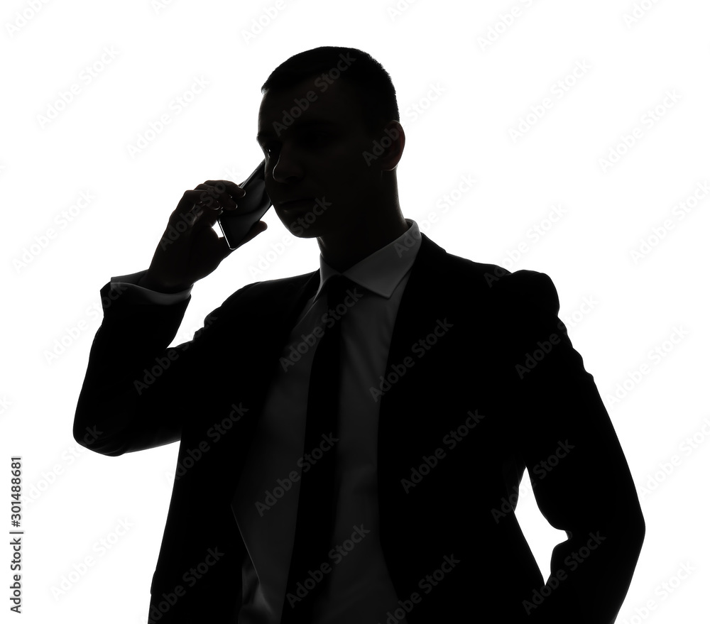 Silhouette of handsome businessman talking by phone on white background