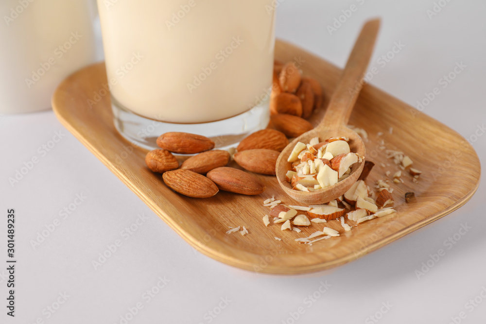 Tasty almond milk on white background