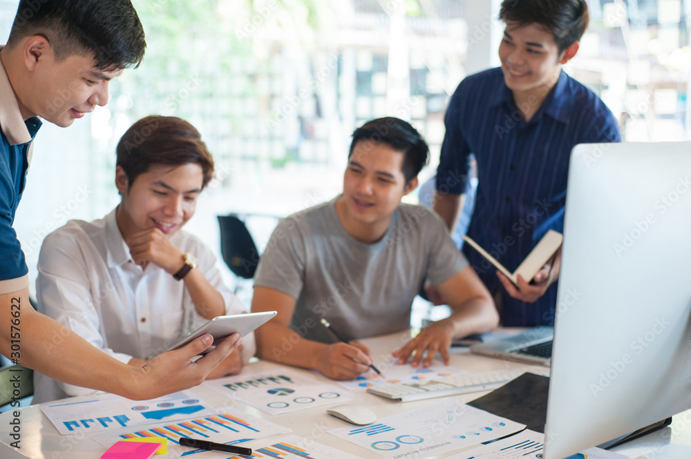 Young businessmen meet to brainstorm, discuss, and plan business initiatives.