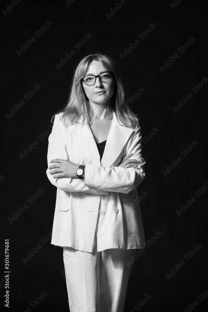 Black and white portrait of stylish businesswoman on dark background