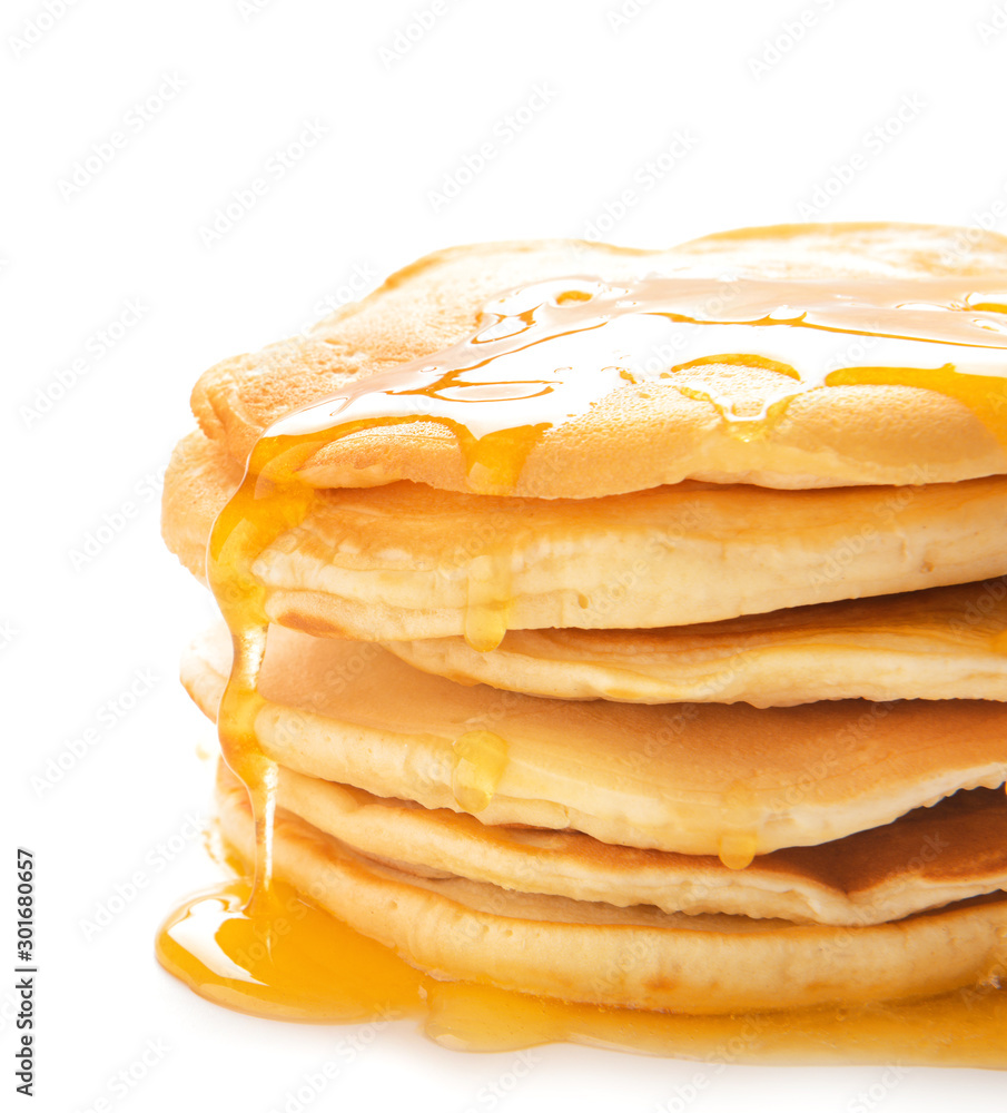 Stack of tasty pancakes with honey on white background