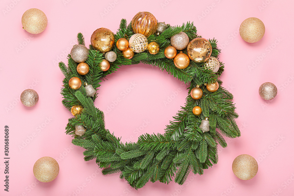 Beautiful Christmas wreath and decor on color background