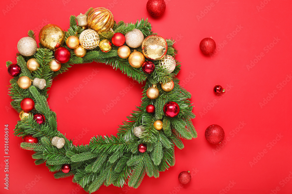 Beautiful Christmas wreath and decor on color background