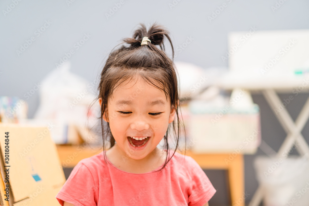 Happy Little asian girl child showing front teeth with big smile and laughing: Healthy happy funny s