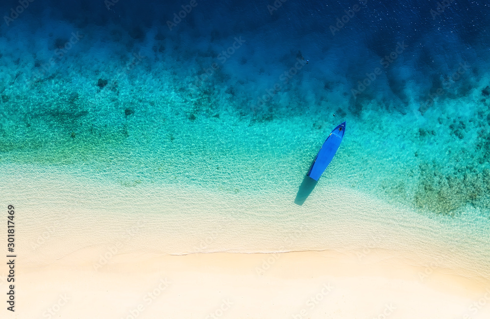 Boat on the water surface from top view. Azure water background from top view. Summer seascape from 