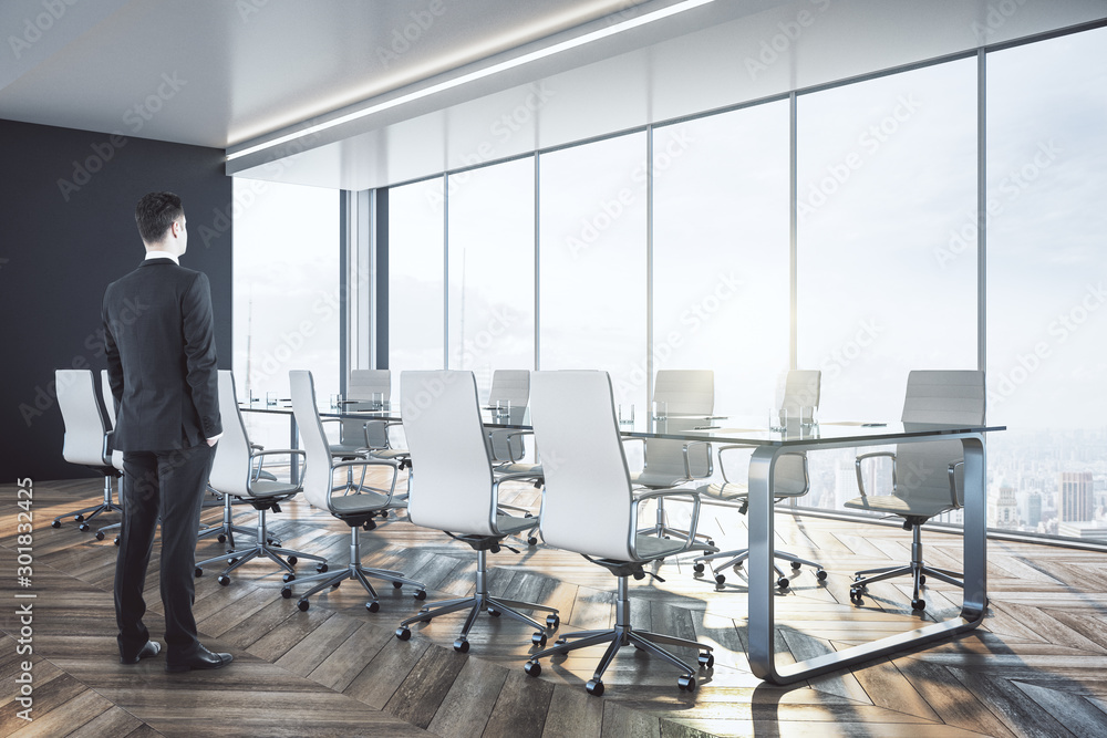 Businessman standing in luxury meeting room