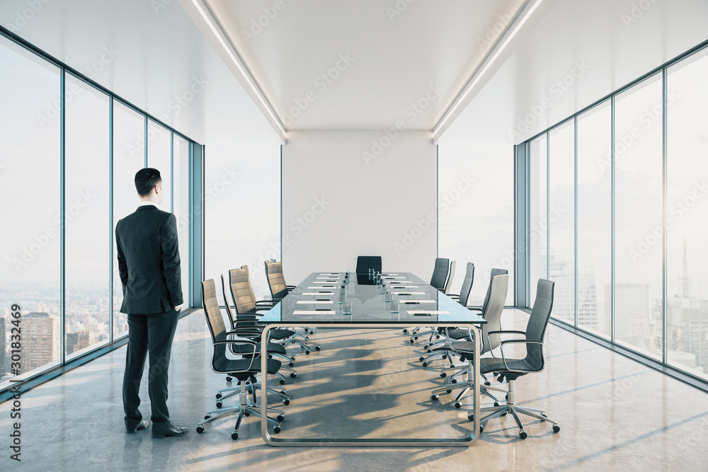 Businessman standing in modern meeting room