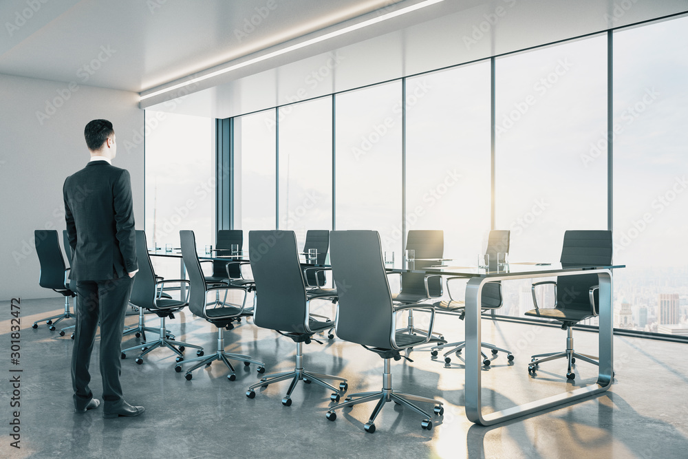 Businessman standing in contemporary meeting room