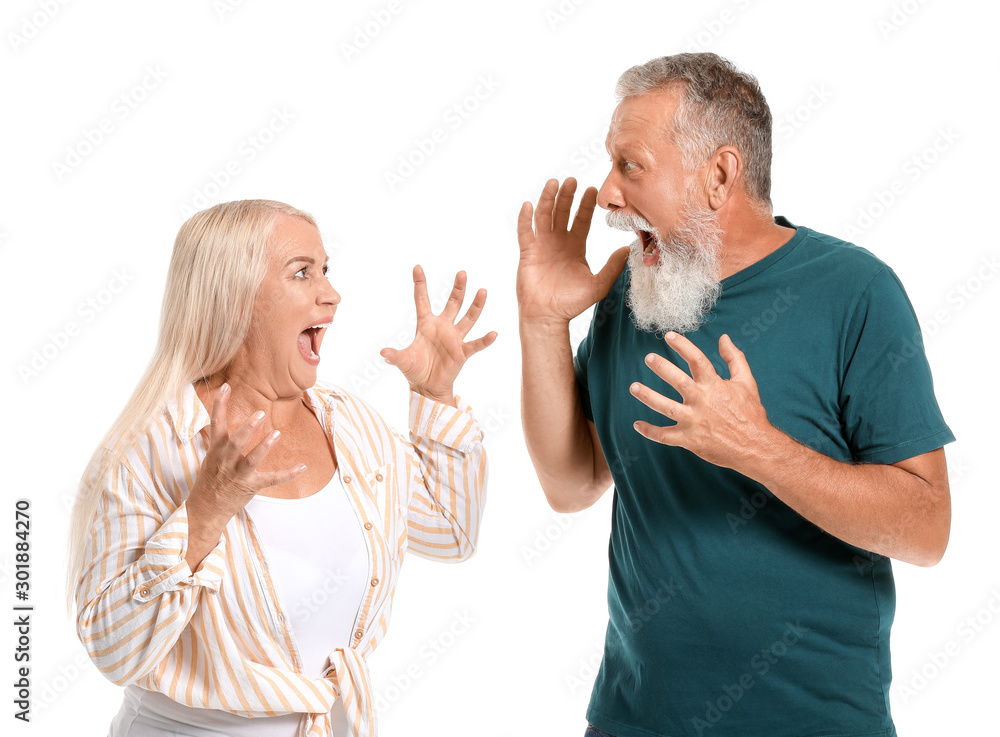 Angry mature couple having arguments against white background