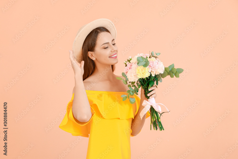 Beautiful young woman with bouquet of carnation flowers on color background