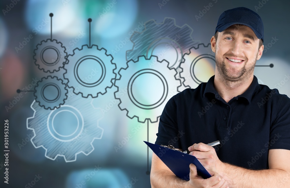 Portrait of cheerful Handsome  mechanic  on background