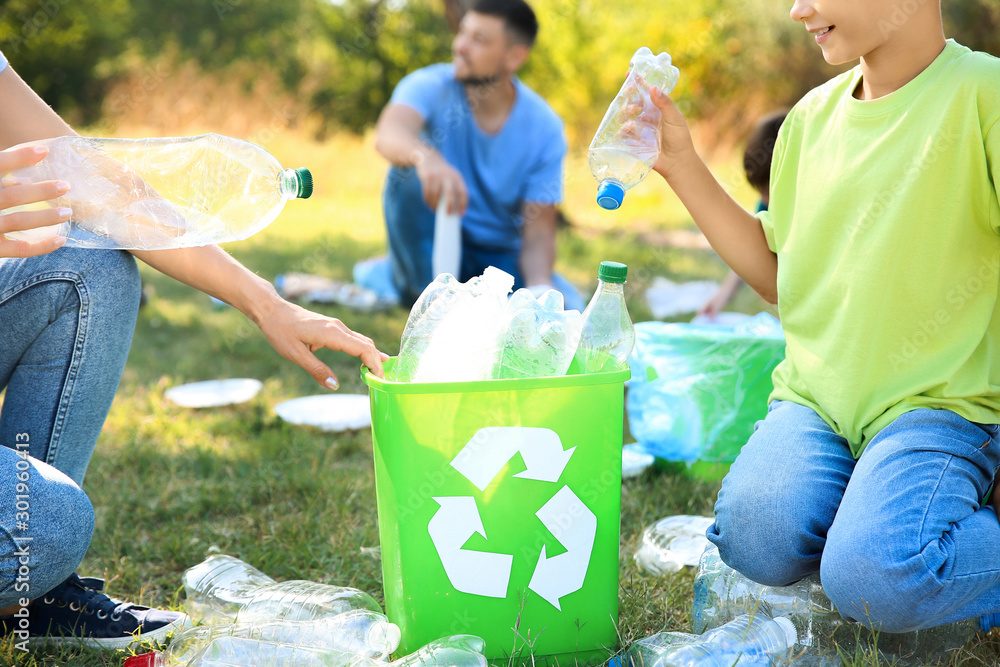 People gathering garbage outdoors. Concept of recycling