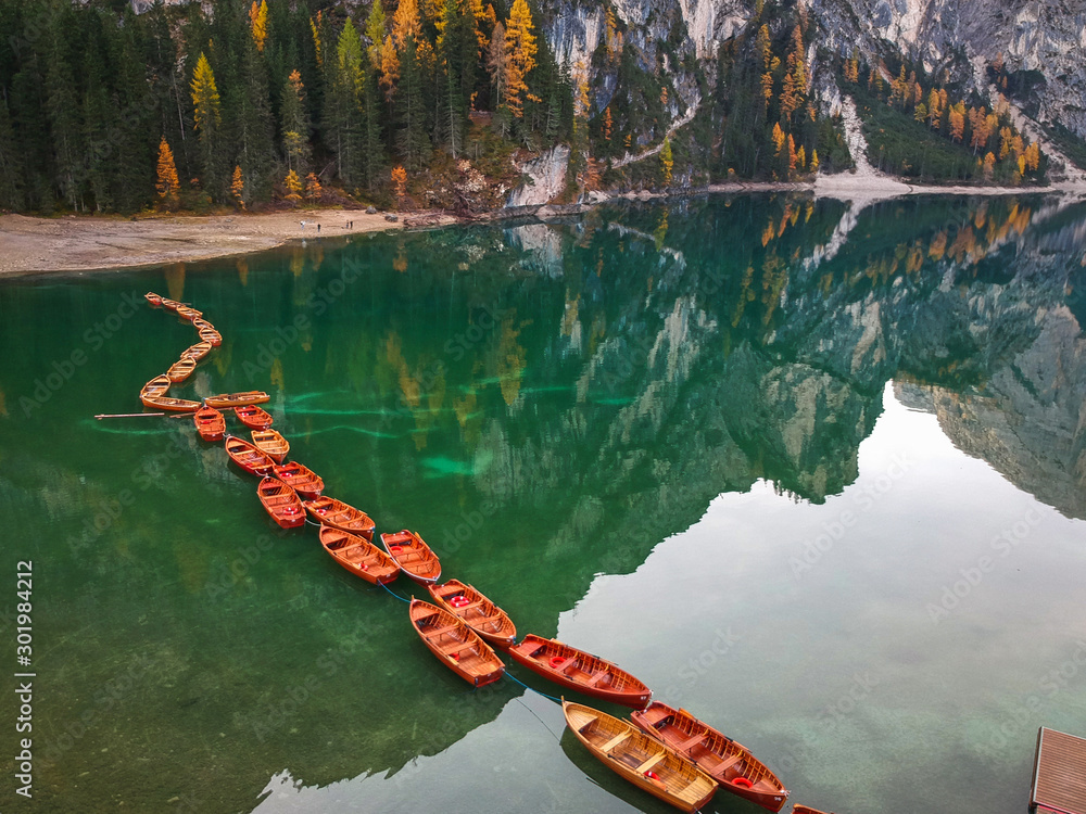 Boats on the Lago di Braies lake in Dolomites at sunrise, Italy