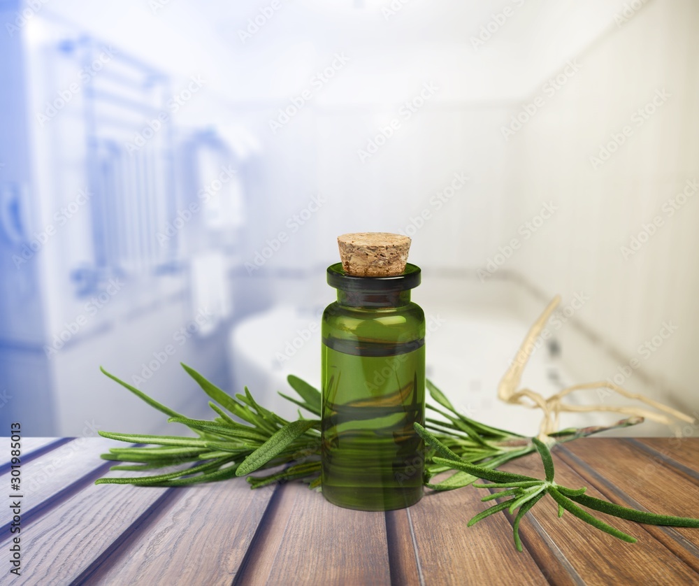 Pile of lavender flowers and a dropper bottle with lavender essence