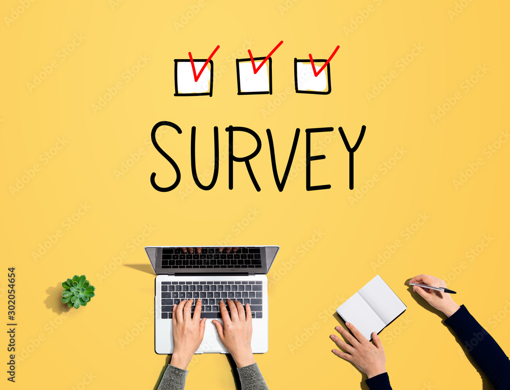 Survey with people working together with laptop and notebook