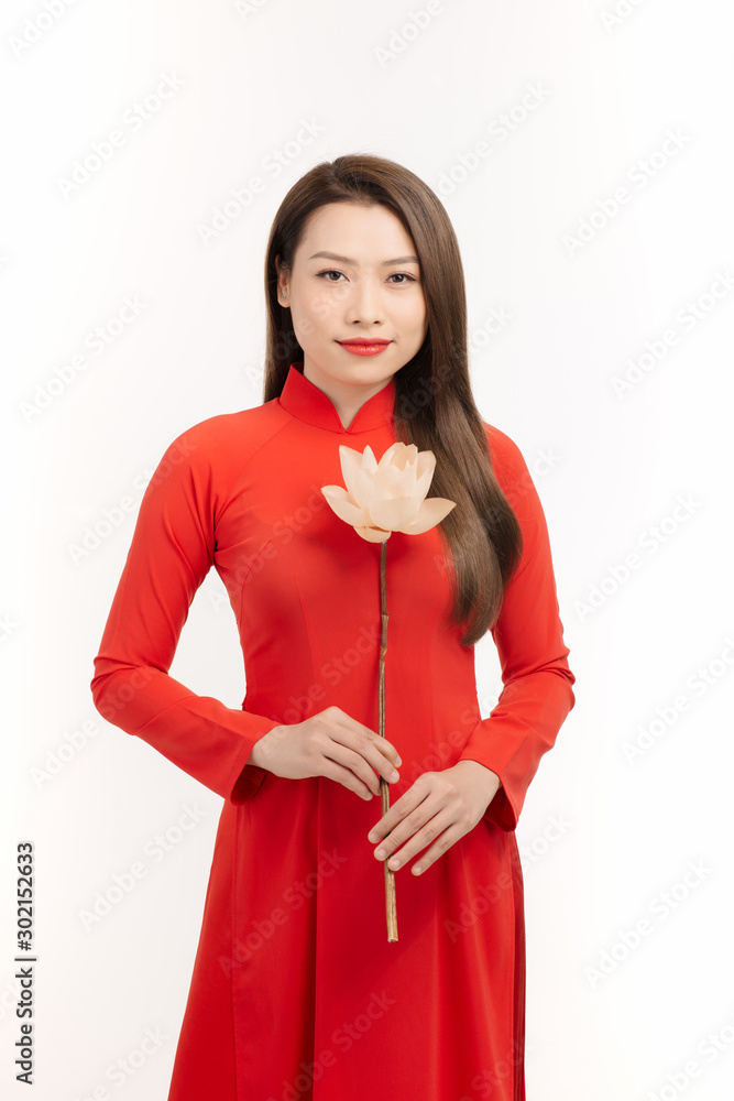 Beauty Vietnamese women wear traditional dress with lotus flower in her hand