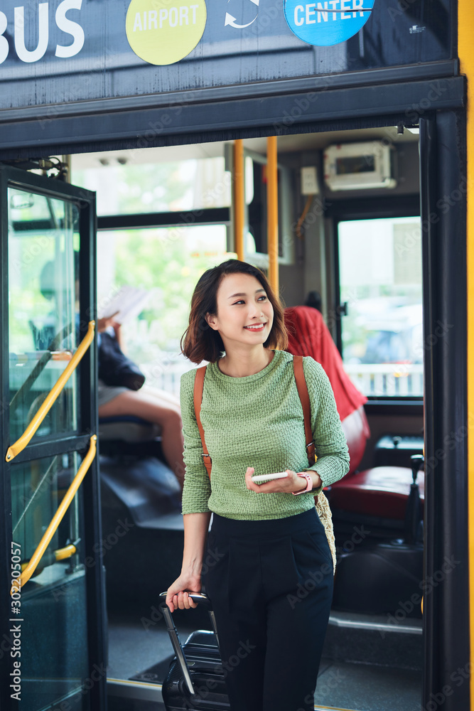 Female traveler going off the bus at terminal