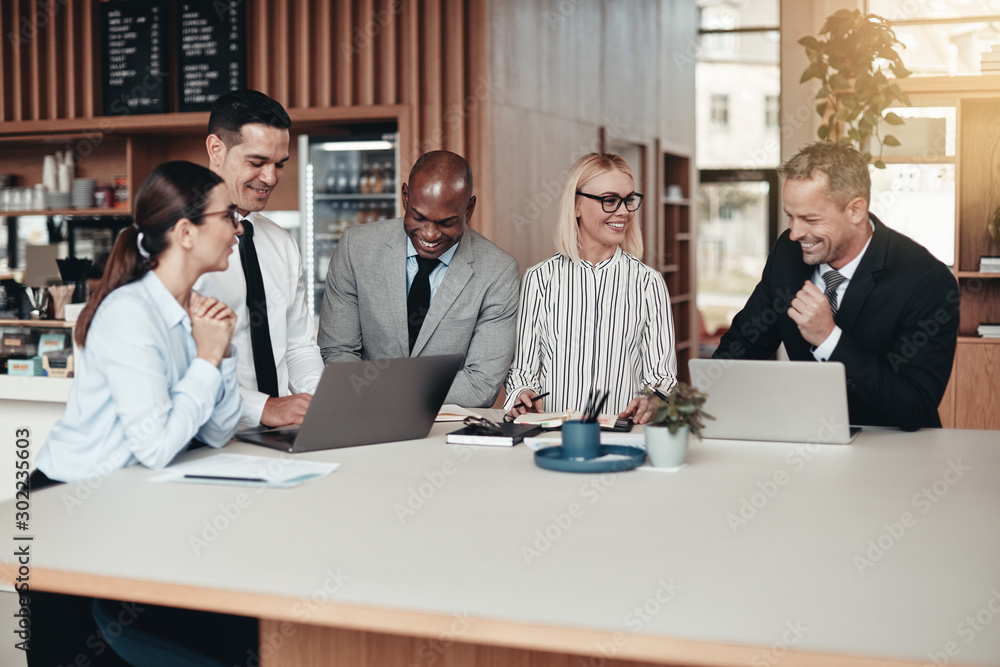 Diverse group of laughing businesspeople working in an office