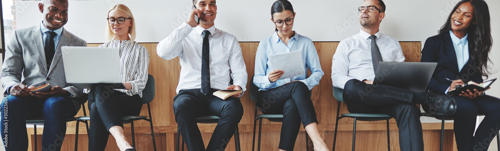 Smiling diverse businesspeople sitting together in an office rec