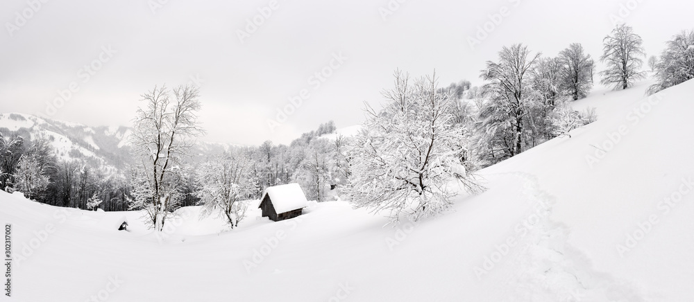 Fantastic winter landscape with wooden house in snowy mountains. Christmas holiday concept